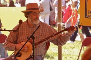 Roger tunes his banjo at the New Jersey Folk Festival. (photo by Bob Yahn)