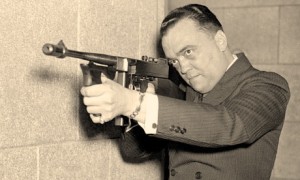 FBI Director J. Edgar Hoover (1895-1972) with tommy gun (1930s) (photo: Gonzaga University)