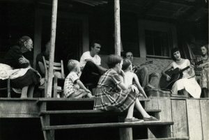 Hazel Dickens (2nd frm rt) performs for family of Sophronie Miller Greer (far left) (1960) (Ralph Rinzler Papers; Smithsonian Folkways).